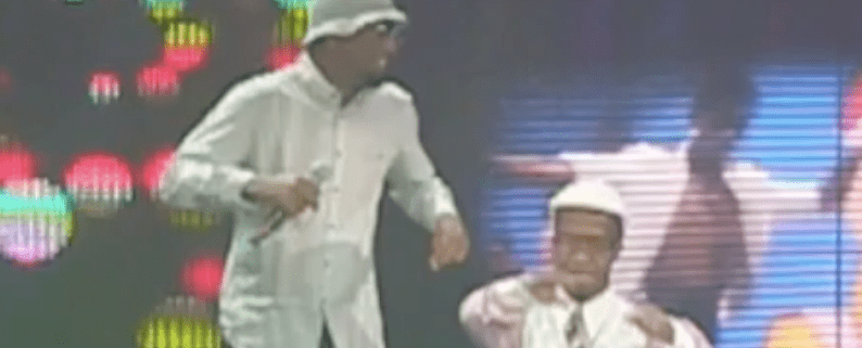 Two performers dancing on a colorful stage.